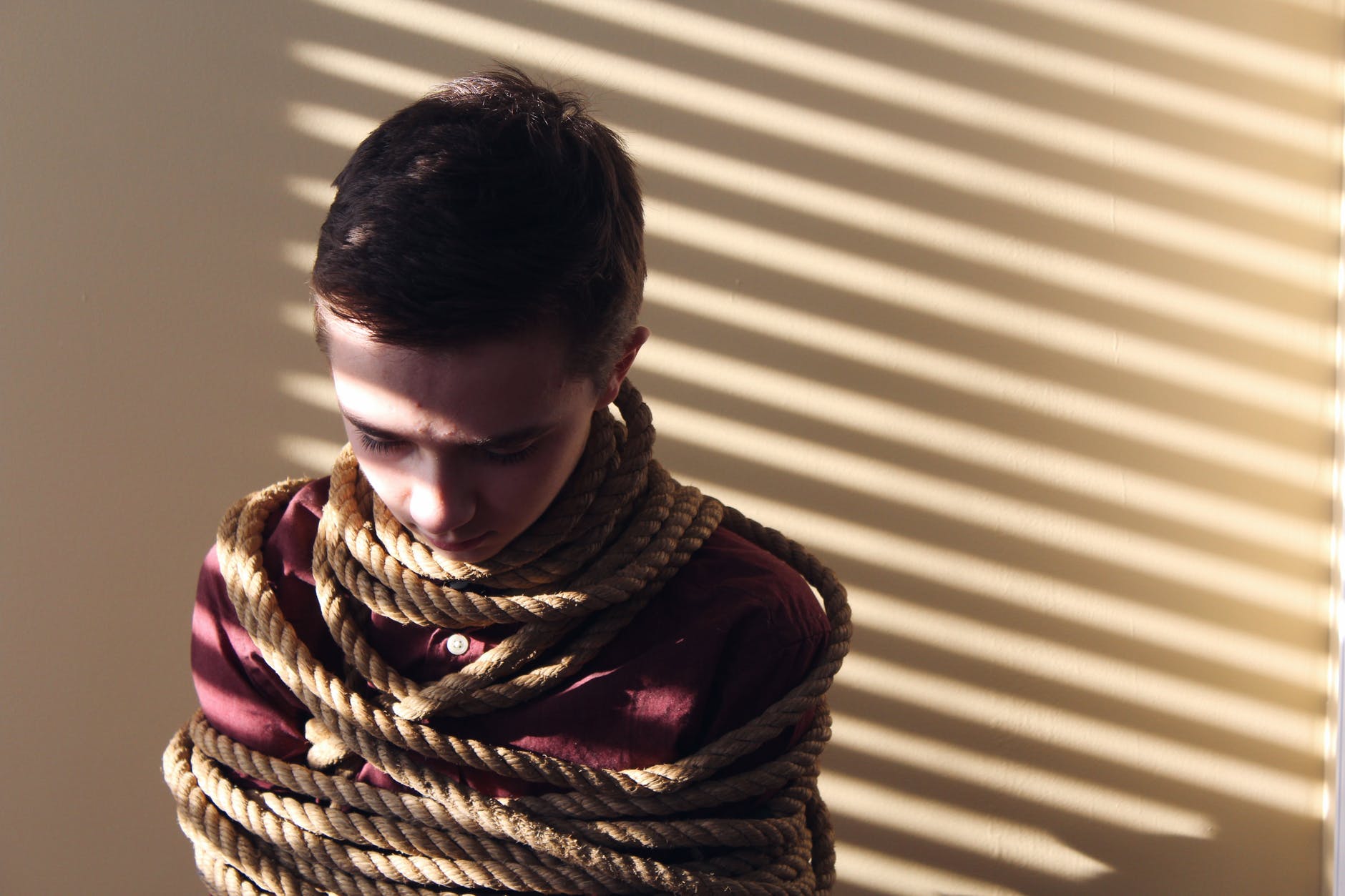 photo of a boy tied with ropes